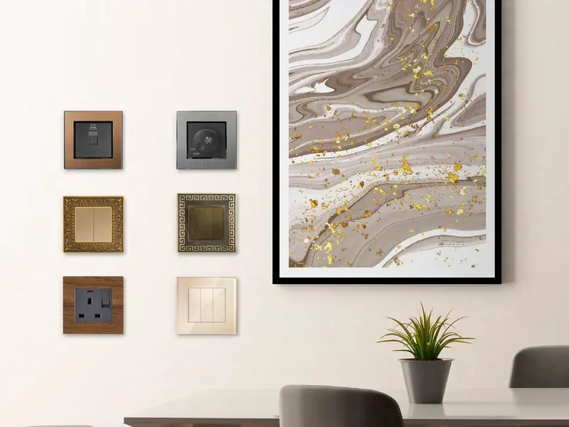 Wall of designer switches and sockets in wood, metal and cream finishes
