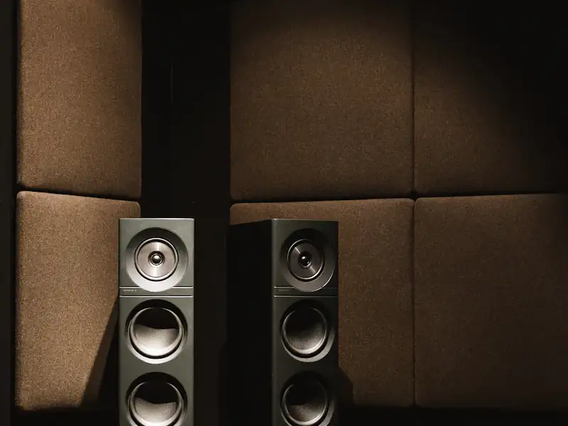 Pair of slim floor-standing speakers in a listening room